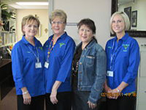 Four females smiling in business office