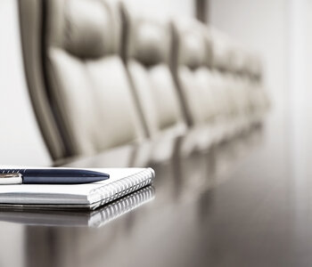 board chairs with notebook and pen